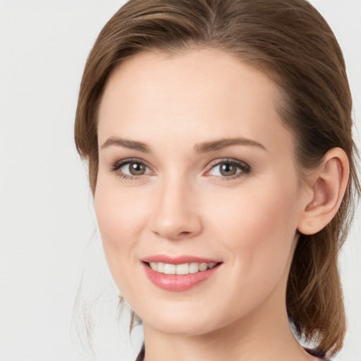 Joyful white young-adult female with medium  brown hair and grey eyes