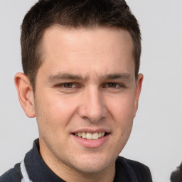 Joyful white young-adult male with short  brown hair and brown eyes