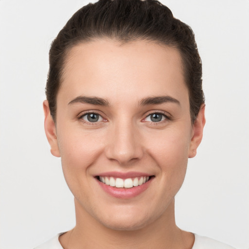 Joyful white young-adult female with short  brown hair and brown eyes