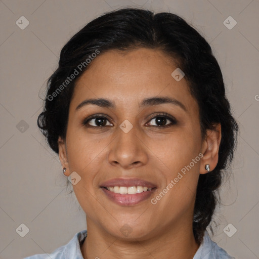 Joyful latino adult female with medium  brown hair and brown eyes