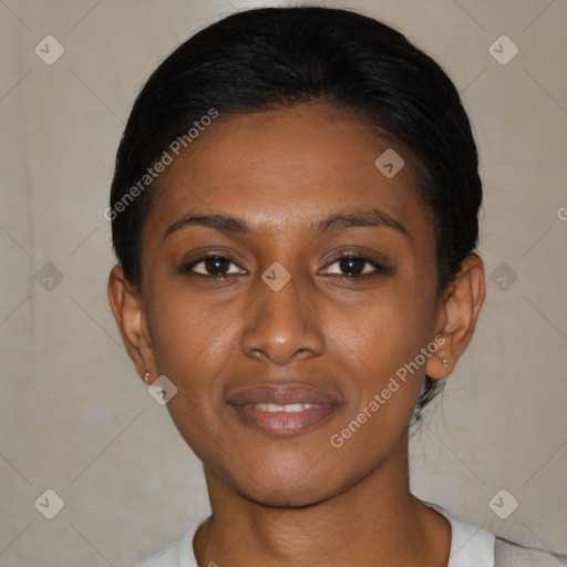 Joyful black young-adult female with short  black hair and brown eyes