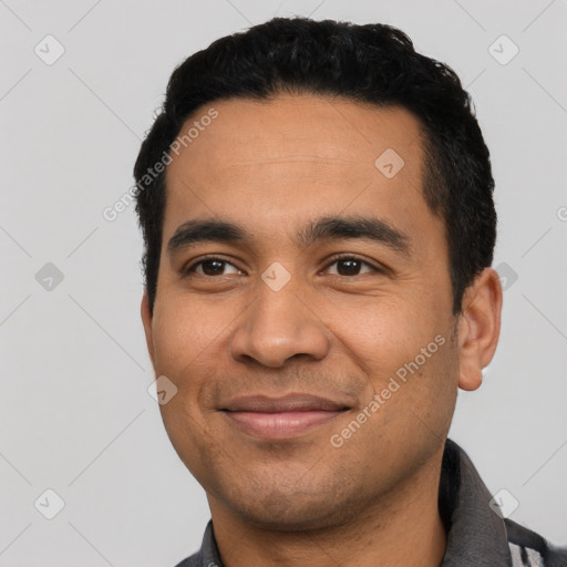 Joyful latino young-adult male with short  black hair and brown eyes