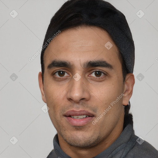 Joyful white young-adult male with short  black hair and brown eyes