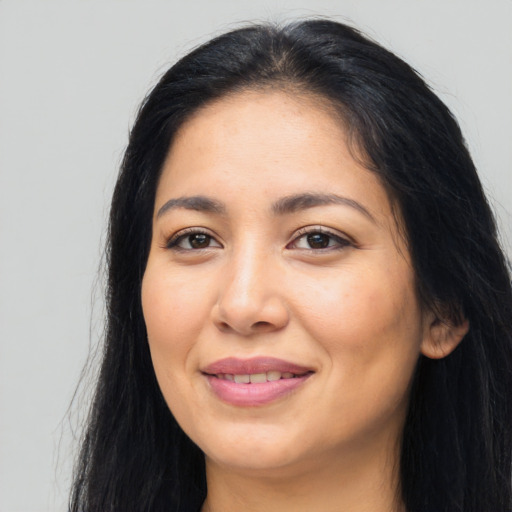 Joyful latino young-adult female with long  black hair and brown eyes