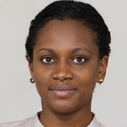 Joyful black young-adult female with short  black hair and brown eyes