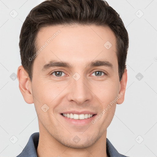 Joyful white young-adult male with short  brown hair and grey eyes