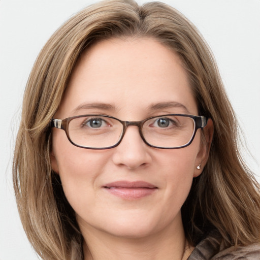 Joyful white young-adult female with long  brown hair and blue eyes