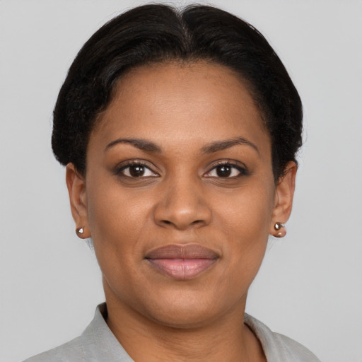 Joyful black young-adult female with short  brown hair and brown eyes