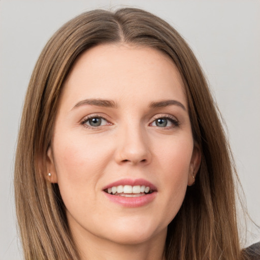 Joyful white young-adult female with long  brown hair and grey eyes