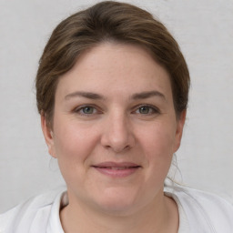 Joyful white young-adult female with short  brown hair and grey eyes