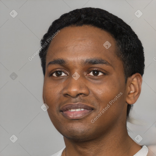 Joyful black young-adult male with short  black hair and brown eyes