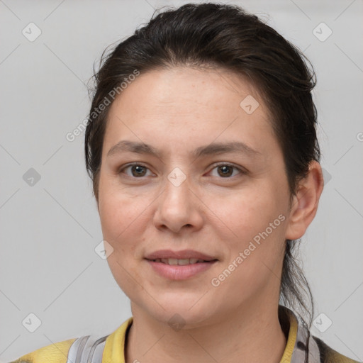 Joyful white adult female with medium  brown hair and brown eyes