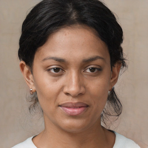 Joyful latino young-adult female with medium  brown hair and brown eyes