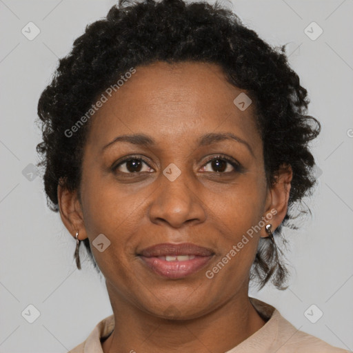 Joyful black adult female with short  brown hair and brown eyes