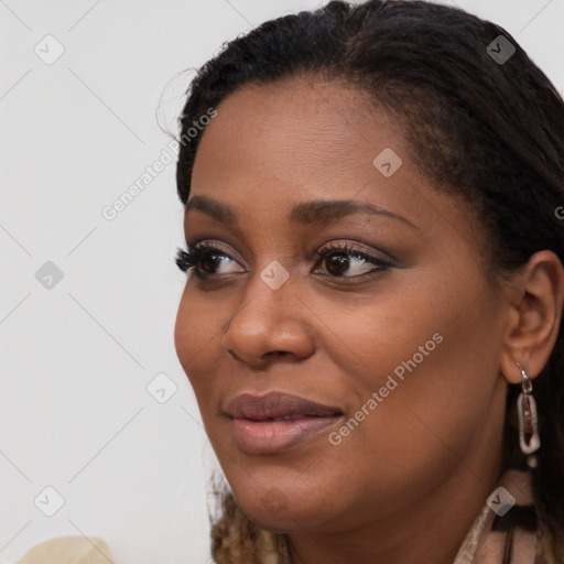 Joyful black young-adult female with long  black hair and brown eyes