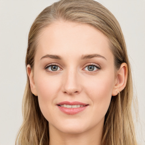 Joyful white young-adult female with long  brown hair and blue eyes