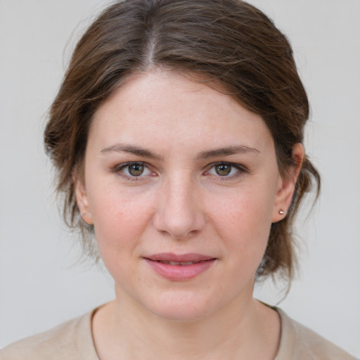 Joyful white young-adult female with medium  brown hair and grey eyes