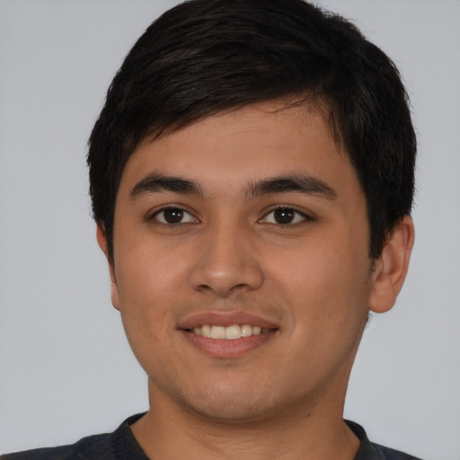 Joyful asian young-adult male with short  black hair and brown eyes