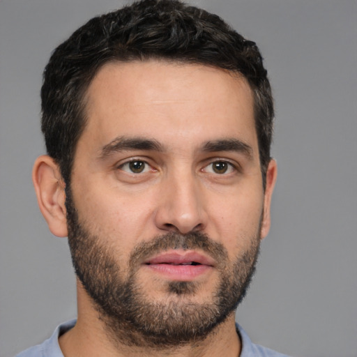 Joyful white young-adult male with short  black hair and brown eyes