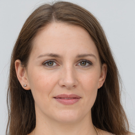 Joyful white adult female with long  brown hair and grey eyes