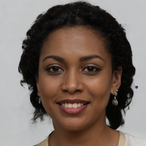 Joyful black young-adult female with medium  brown hair and brown eyes