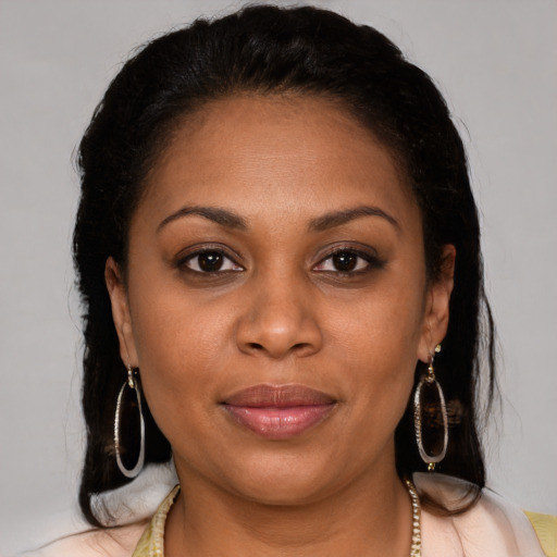Joyful black young-adult female with medium  brown hair and brown eyes