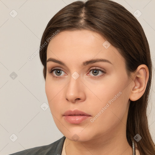 Neutral white young-adult female with long  brown hair and brown eyes