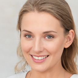 Joyful white young-adult female with medium  brown hair and blue eyes