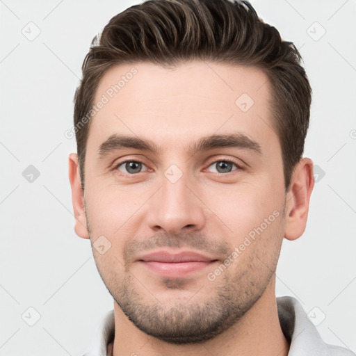 Joyful white young-adult male with short  brown hair and brown eyes