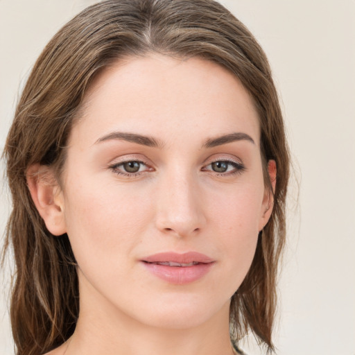 Joyful white young-adult female with long  brown hair and green eyes