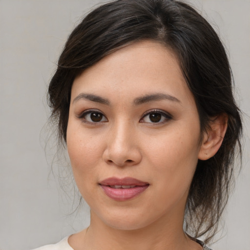 Joyful asian young-adult female with medium  brown hair and brown eyes