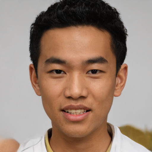 Joyful asian young-adult male with short  black hair and brown eyes