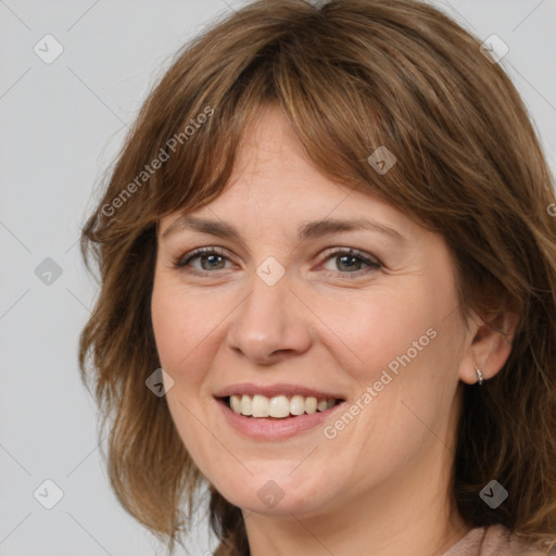 Joyful white adult female with medium  brown hair and grey eyes