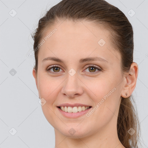 Joyful white young-adult female with long  brown hair and brown eyes