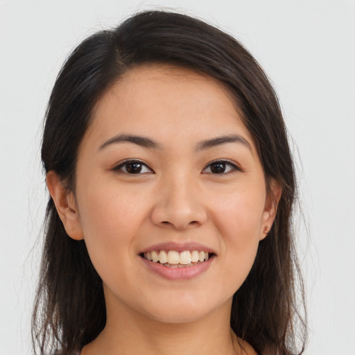 Joyful asian young-adult female with long  brown hair and brown eyes