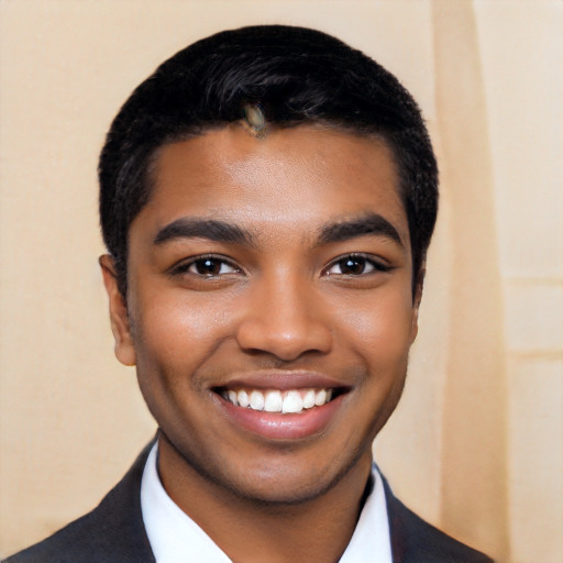 Joyful black young-adult male with short  black hair and brown eyes