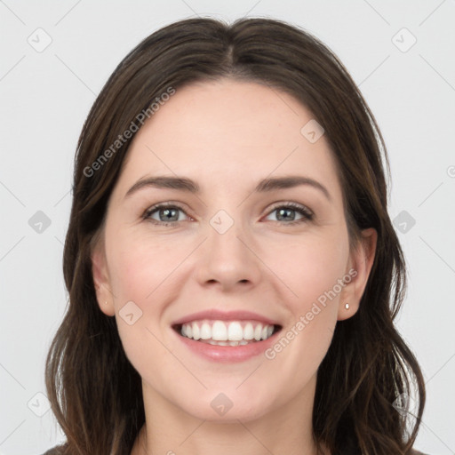 Joyful white young-adult female with long  brown hair and grey eyes