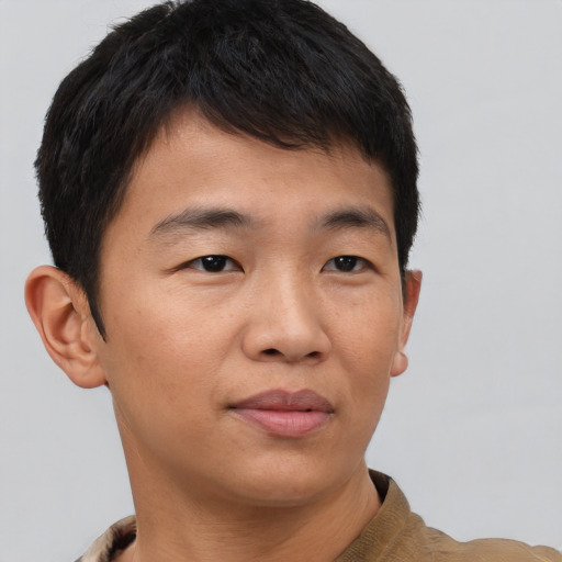 Joyful asian young-adult male with short  brown hair and brown eyes