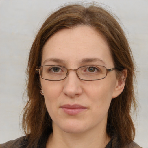 Joyful white adult female with long  brown hair and grey eyes