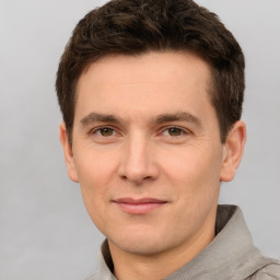 Joyful white young-adult male with short  brown hair and brown eyes