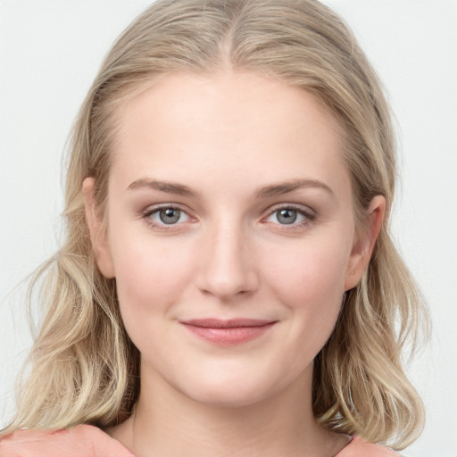 Joyful white young-adult female with long  brown hair and blue eyes