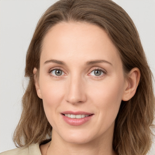 Joyful white young-adult female with long  brown hair and grey eyes