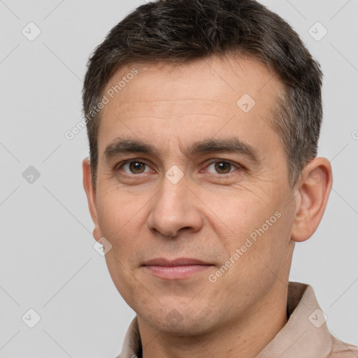 Joyful white adult male with short  brown hair and brown eyes