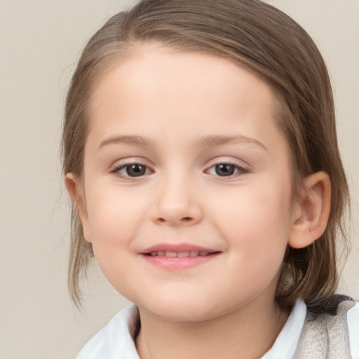 Joyful white child female with medium  brown hair and brown eyes