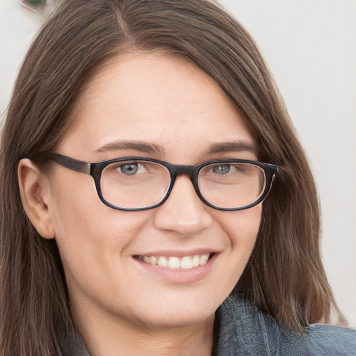 Joyful white young-adult female with long  brown hair and blue eyes