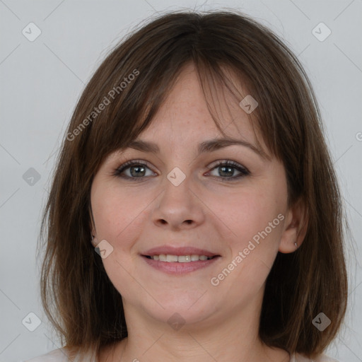 Joyful white young-adult female with medium  brown hair and grey eyes