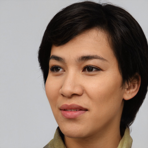 Joyful asian young-adult female with medium  black hair and brown eyes