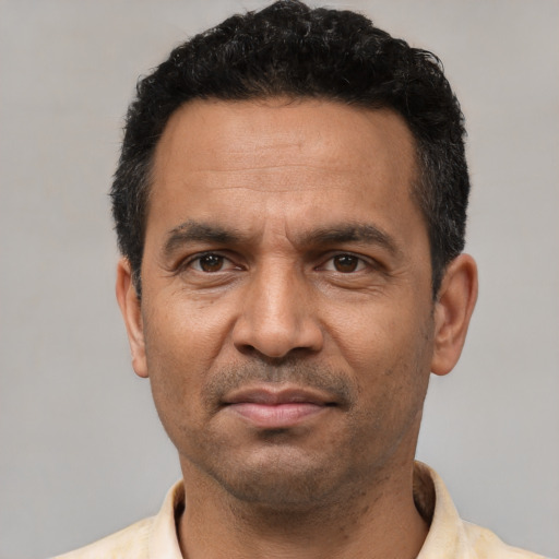 Neutral latino adult male with short  black hair and brown eyes
