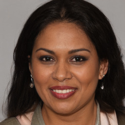 Joyful white adult female with medium  brown hair and brown eyes