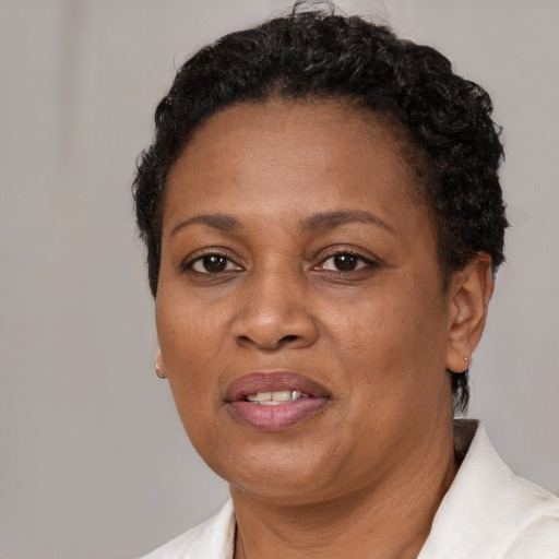 Joyful black adult female with short  brown hair and brown eyes